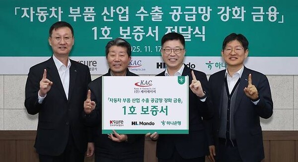 하나은행은 지난 17일 HL만도, 한국무역보험공사와 함께 자동차 부품산업 수출 공금망 강화를 위한 금융지원 1호 지원 기업인 케이에이씨를 방문했다. 강원도 원주시 케이에이씨 반계공장에서 열린 보증서 전달식에 참석한 진건창 하나은행 외환사업본부장(왼쪽 세번째)이 김성일 HL만도 부사장(왼쪽 첫번째), 하영봉 케이에이씨 대표이사(왼쪽 두번째), 장진욱 한국무역보험공사 부사장과 기념촬영을 하고 있다. [사진=하나은행 제공]