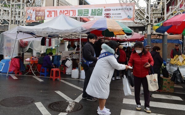 경상원 직원들이 여주한글시장을 방문한 도민들에게 '통큰 세일' 홍보물을 나눠주고 있다 [사진=경상원]